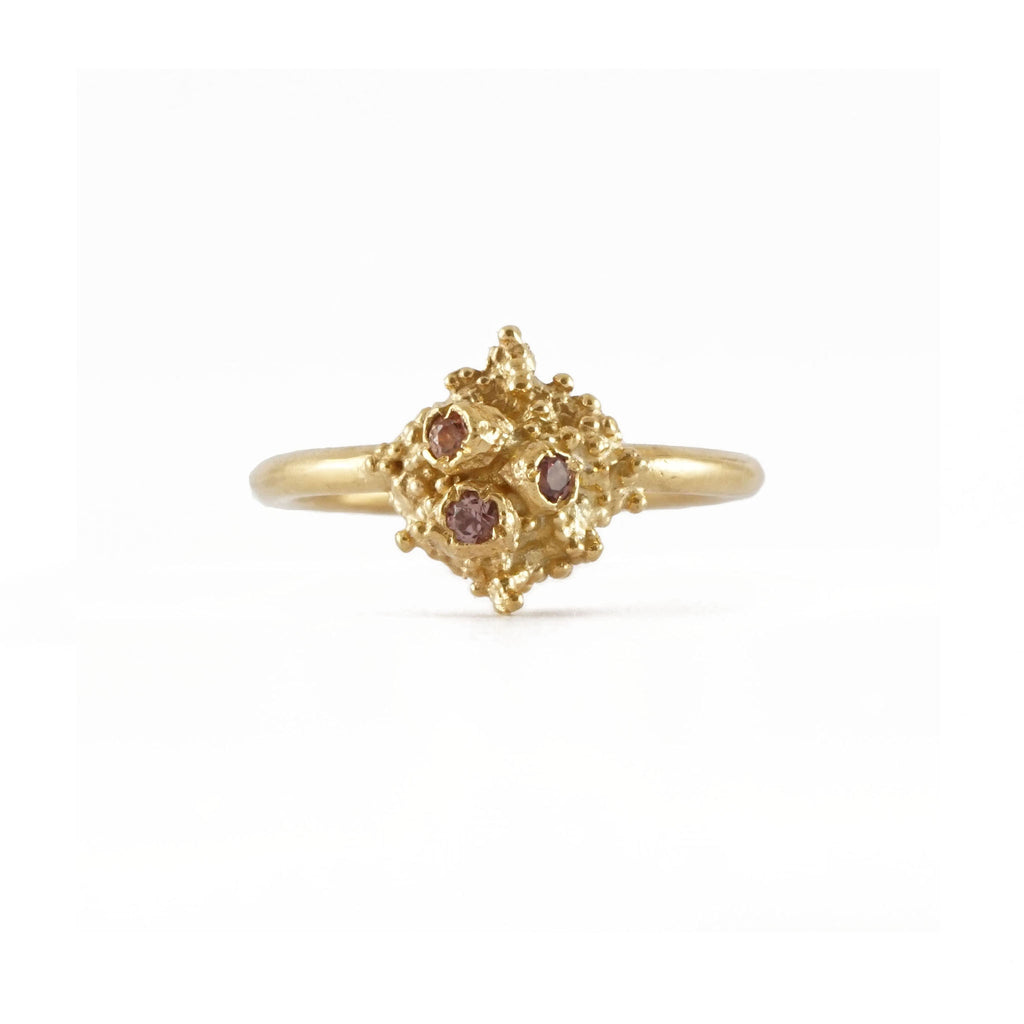 Delicate gold ring set with three light pink Sapphires 