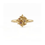 Delicate gold ring set with three light pink Sapphires 