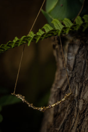 14ct gold twig necklace set with nine colorful Sapphires