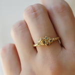 Beautiful 14ct gold ring set with seven green Sapphires